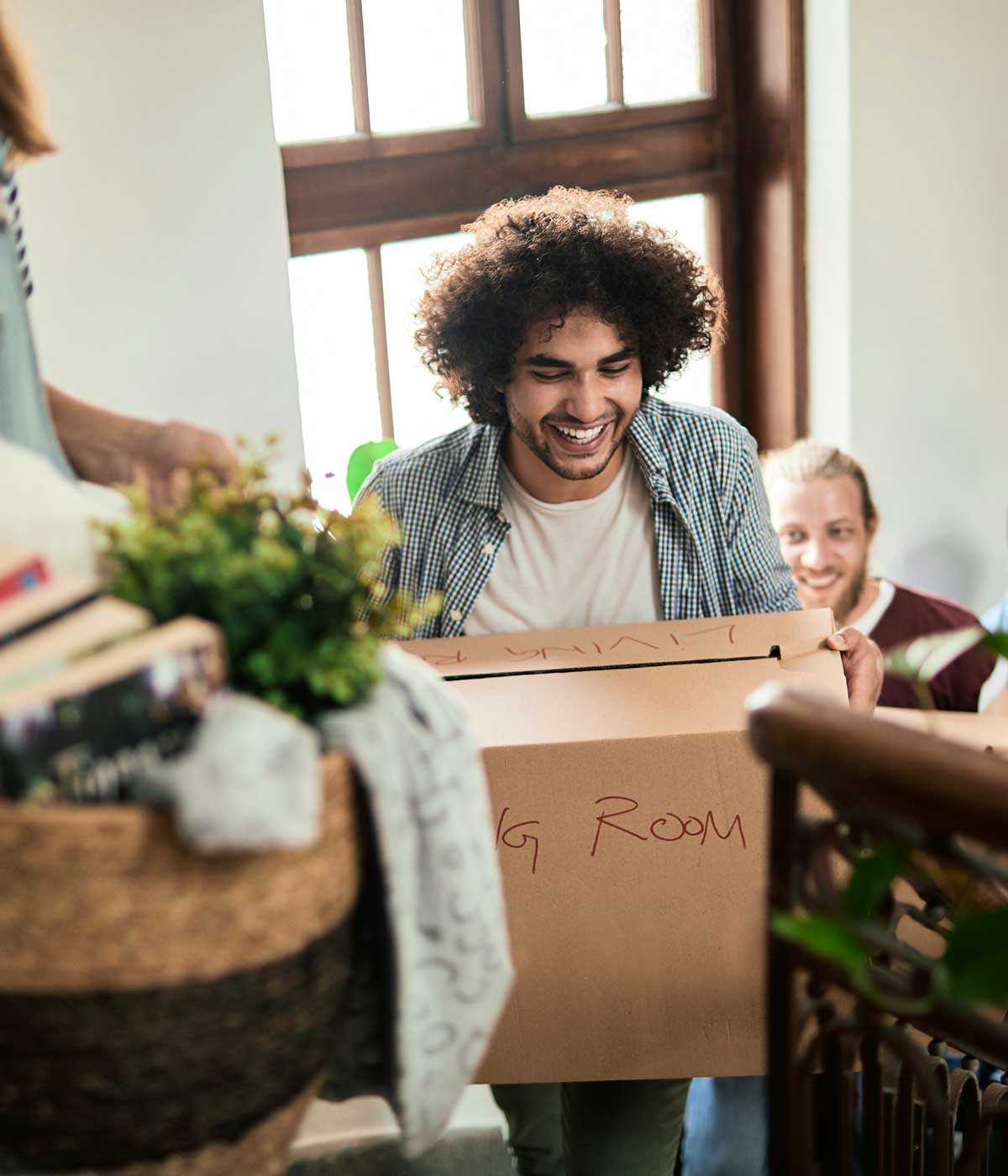 Can international students work in usa, get a work visa for us, or go from F1 to green card? A man interested in a post study work visa USA and work permit for us carries a box up stairs into his new apartment building.