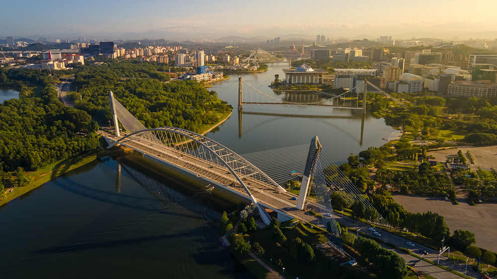 A birds-eye view of a bridge and river in Putrajaya, Malaysia