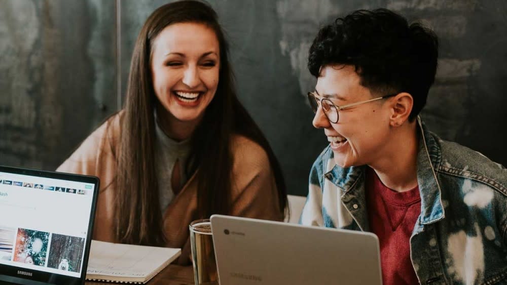 At an internship for students, two female students laugh and talk about how to apply for an internship and how to get an internship during their study abroad program.