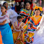 A group of Latina women in traditional dress dance for a festival in Salt Lake City.