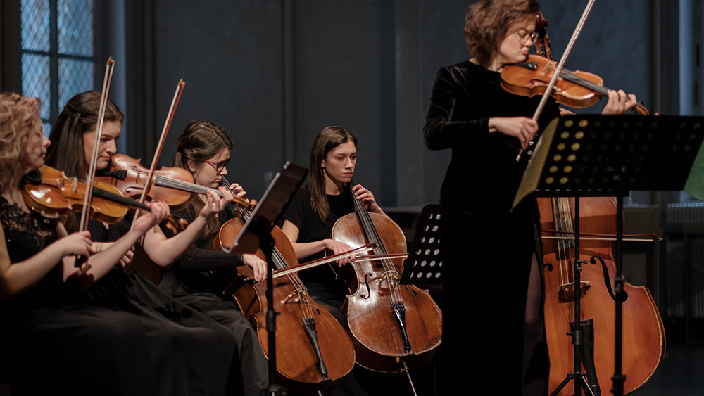 An all-female string section of an orchestra