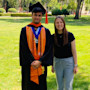 Abdullah from Pakistan, class of 2025 valedictorian at the University of the Pacific, stands on campus in his graduation robes alongside Jelena from UOP International.