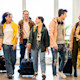 A group of international students with suitcases arrive at their dormitory on move in day for their student exchange program.