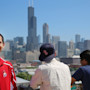 Two University of Illinois - Chicago students on a rooftop with one facing the camera and the other facing the Sears (Willis) Tower in the background.