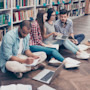 After getting study tips about how to study for test and how to study effectively, a group of international students study together at their college library.