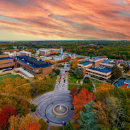 This photo shows an aerial view of Stony Brook University in New York state under a colorful sunset.