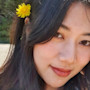Thu Trang, a student ambassador at Auburn Global, smiles for the camera while standing on a beach