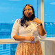 Nandini, an international student from India studying at The University of Texas at San Antonio, stands in front of a wall of windows and looks off camera.