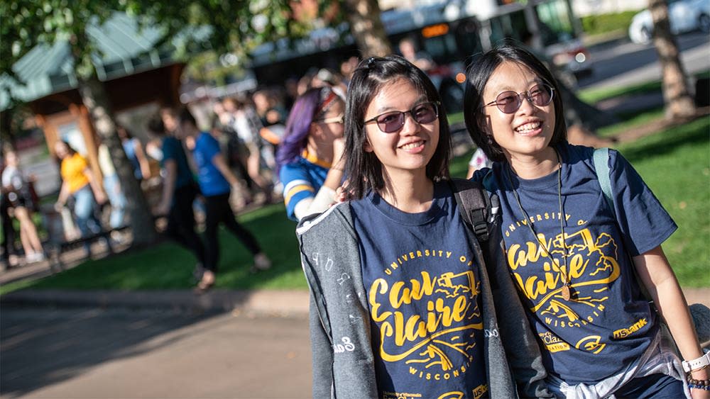 This photo shows two female Asian students standing outside on campus at the University of Wisconsin-Eau Claire
