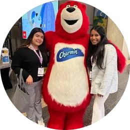Two people with a red Charmin bear
