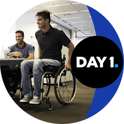 Person in a wheelchair in an office space with 'Day 1' text displayed.