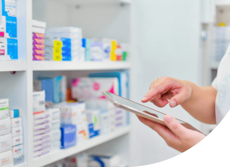 The hand of a person using a tablet at a pharmacy