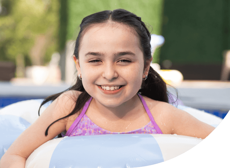 Clare, age 8, living with Rett syndrome, in the pool