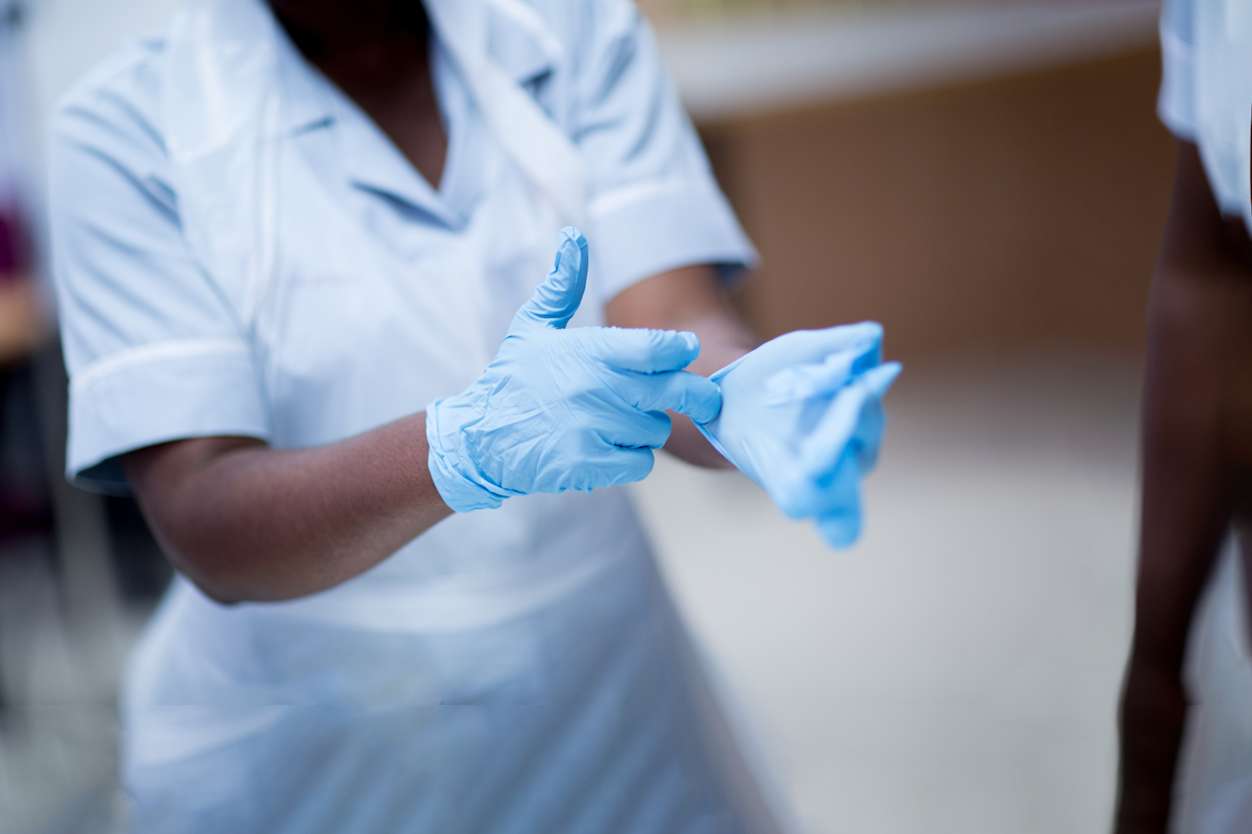 close up of a medical professional putting on surgical gloves
