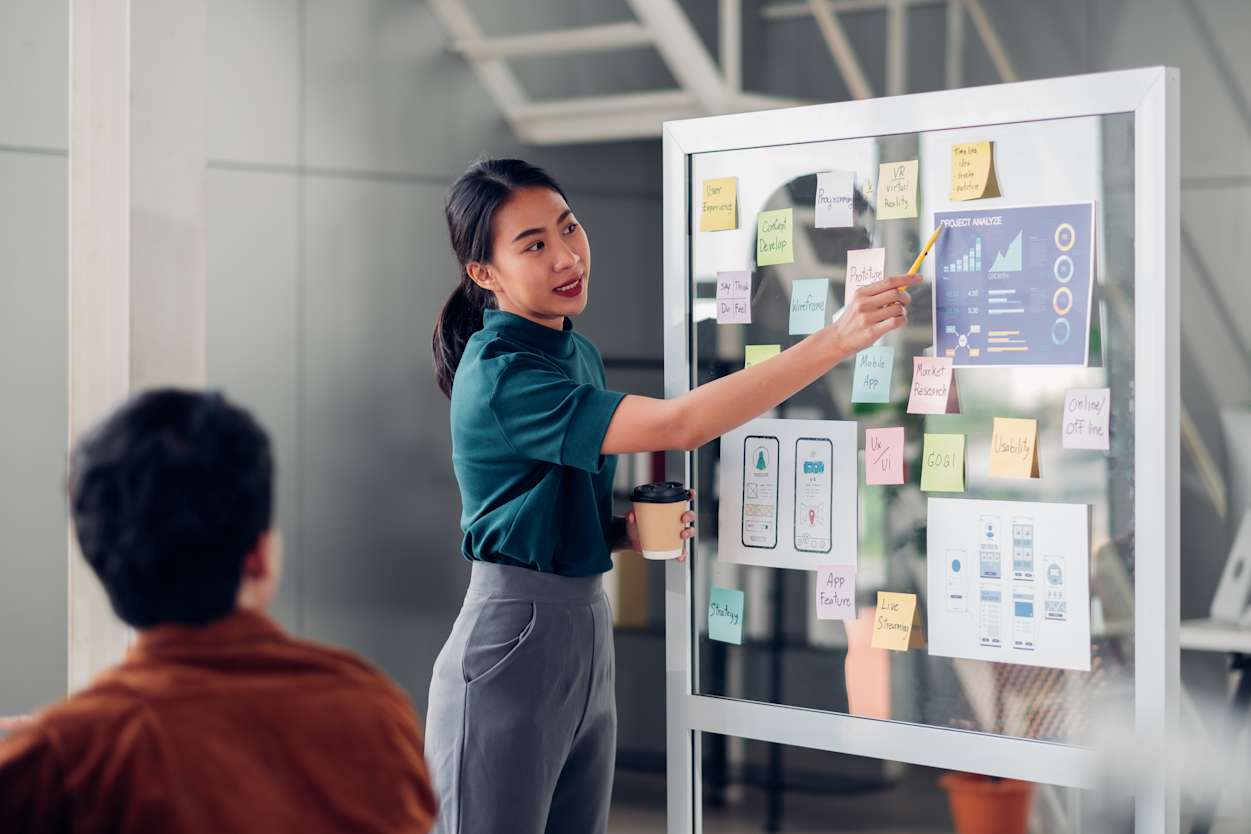 woman presenting on a whiteboard