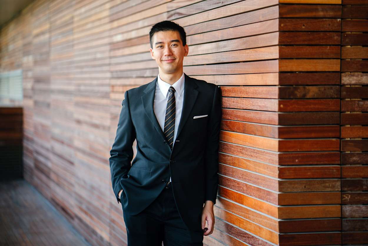 Man in business attire looks at the camera smiling