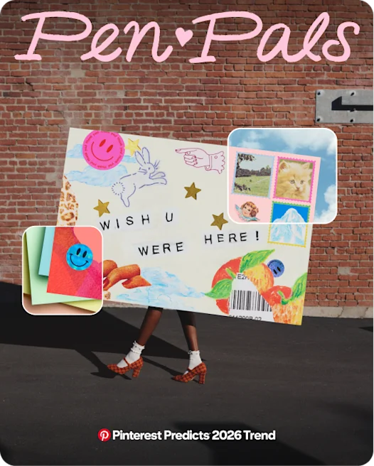 A person walks in front of a brick wall carrying a huge envelope that obscures their body. The envelope says “WISH U WERE HERE!” and is covered in stickers and stamps.