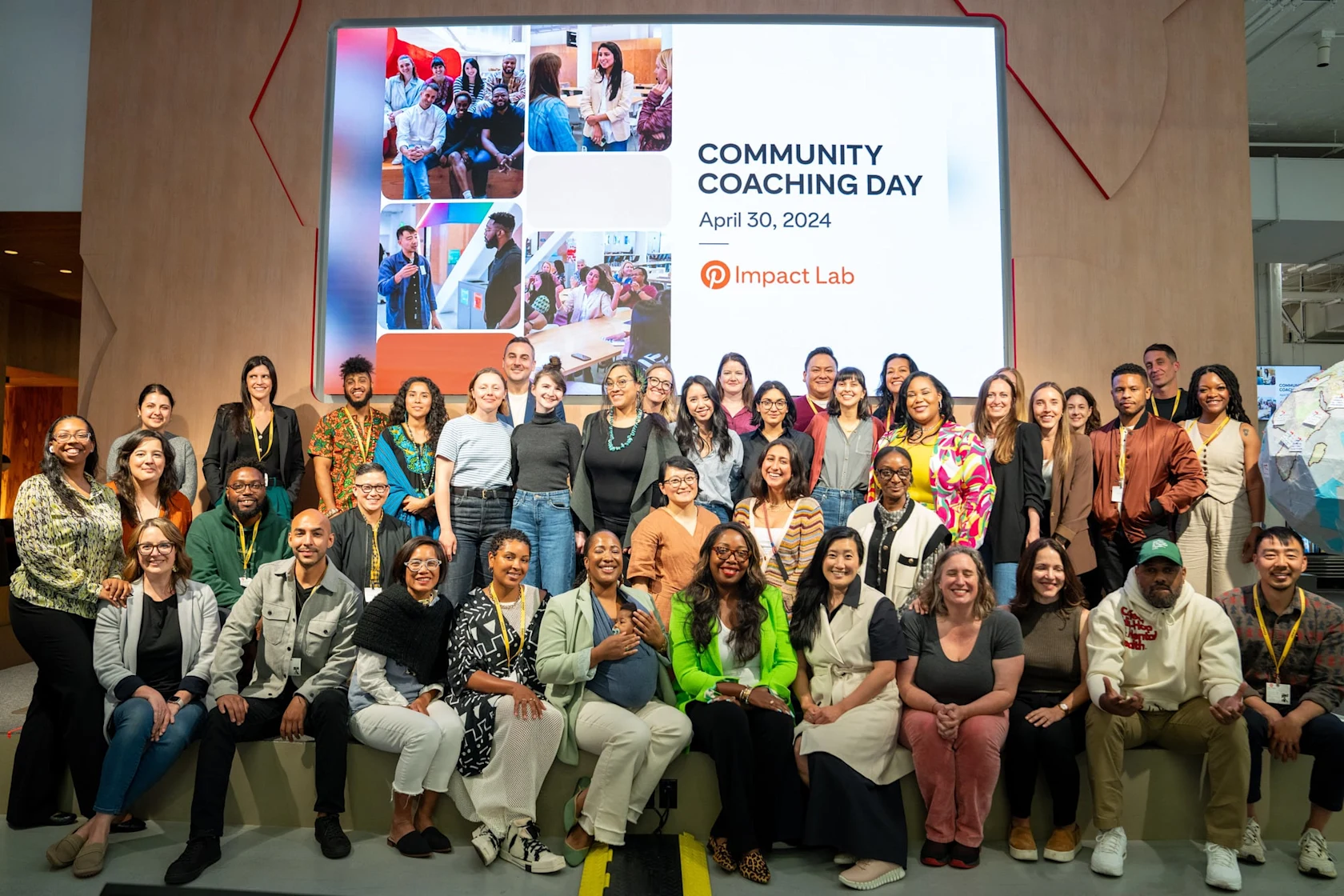 The Pinterest Impact Lab 2024 cohort takes a group photo in front of a projector screen