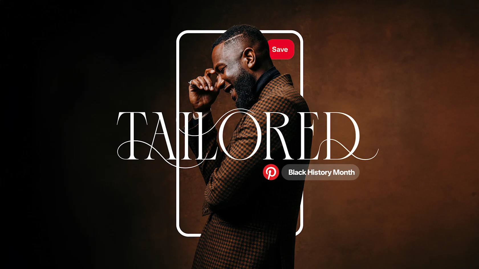 A Black man wearing a tweed jacket with the word "TAILORED" overlaid in a wispy font