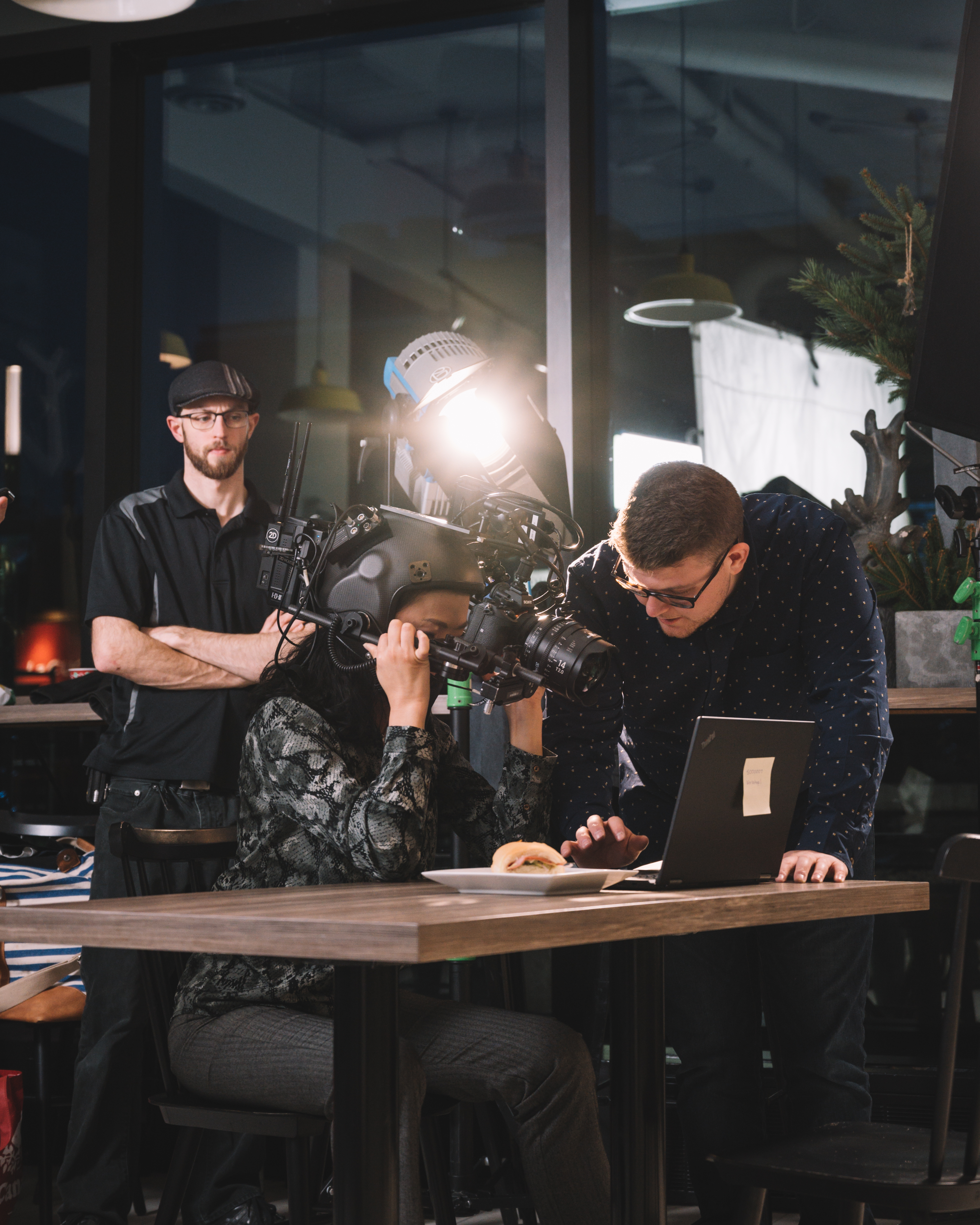 Brandon Hardy directing talent on set while they wear a POV camera rig with a wide lens