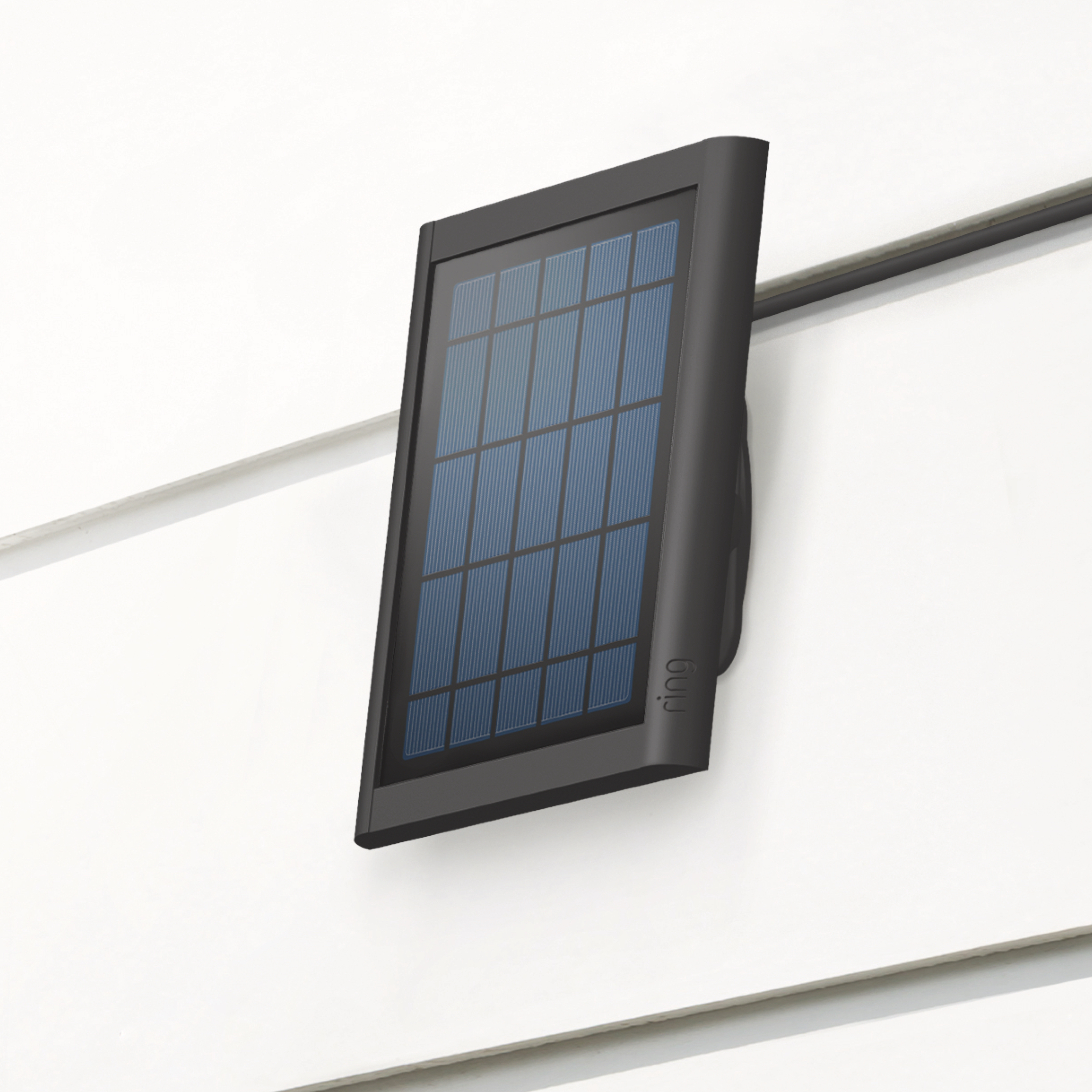 Black Ring Solar Panel mounted on exterior wall, angled to capture sunlight and power Video Doorbell (2nd Gen).