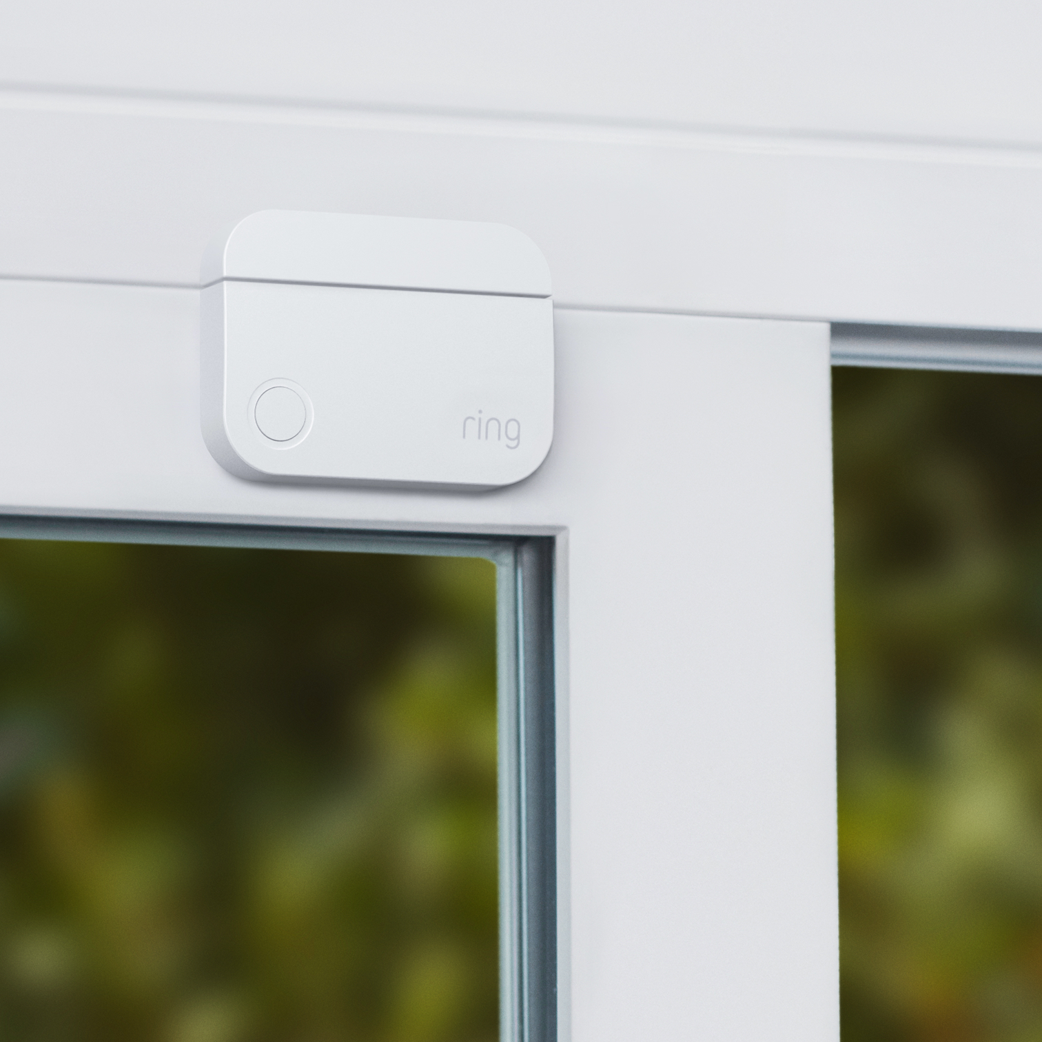 Ring Alarm Contact Sensor (2nd Gen) mounted on white window frame to detect when the window is opened or tampered with.