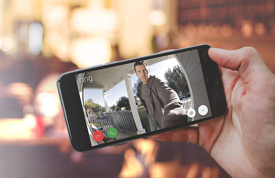 Person viewing live video on smartphone of porch visitor in the Ring app, with motion-activated notification.