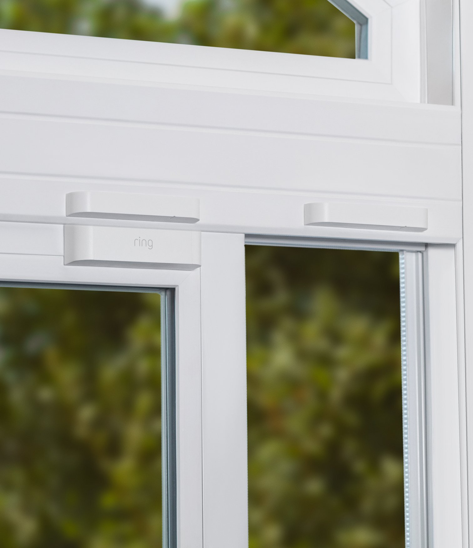 Ring Alarm Contact Sensor installed on white window frame to detect when window is opened or tampered with.