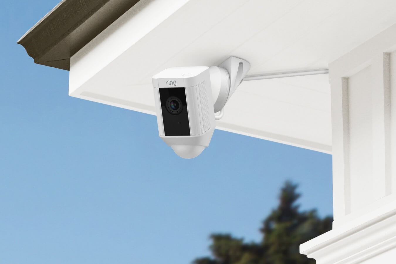 Ring Spotlight Cam Wired mounted under an eave using a ceiling mount for improved motion detection and viewing angle.