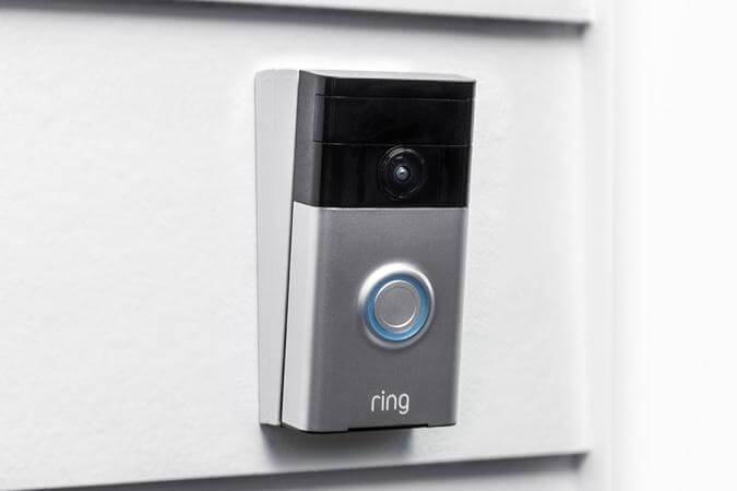 Ring Video Doorbell mounted with wedge kit on home siding to adjust angle for better motion detection and view.