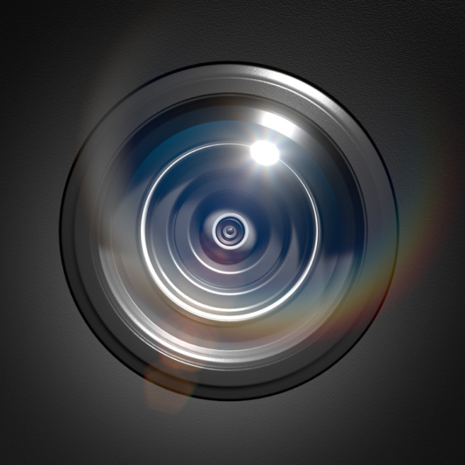 Close-up of camera lens with light reflections, representing Ring's advanced imaging technology and clarity features.