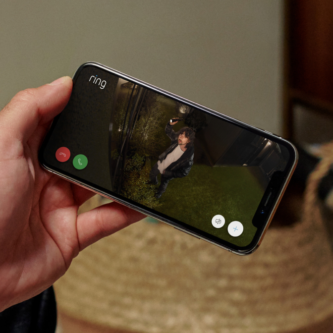Phone displays night-time Ring video of a man outside, captured in sharp 1080p HDR with Colour Night Vision.