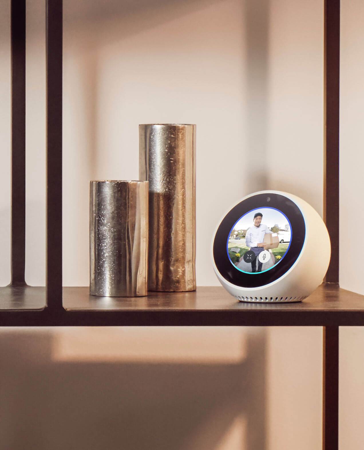 Alexa device shows live video of delivery person with parcel at door, announcing motion alerts from Ring Doorbell.