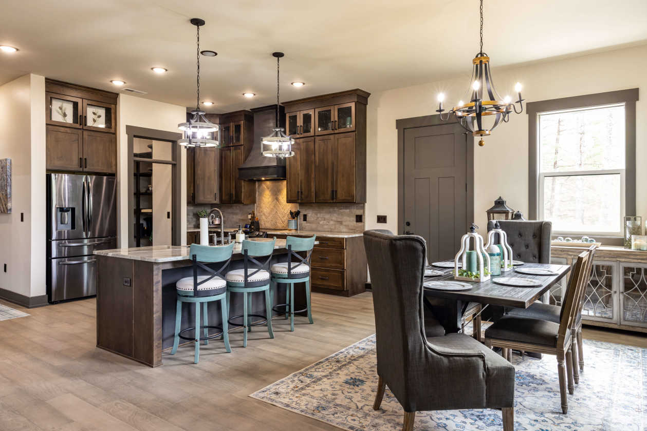 Beautiful finishes and custom lighting make the kitchen and dining room in the Chadwell home feel spacious. 