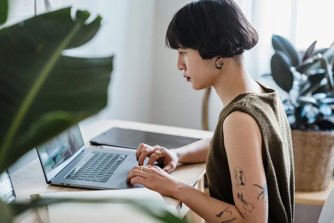 A learner working on a laptop at a desk