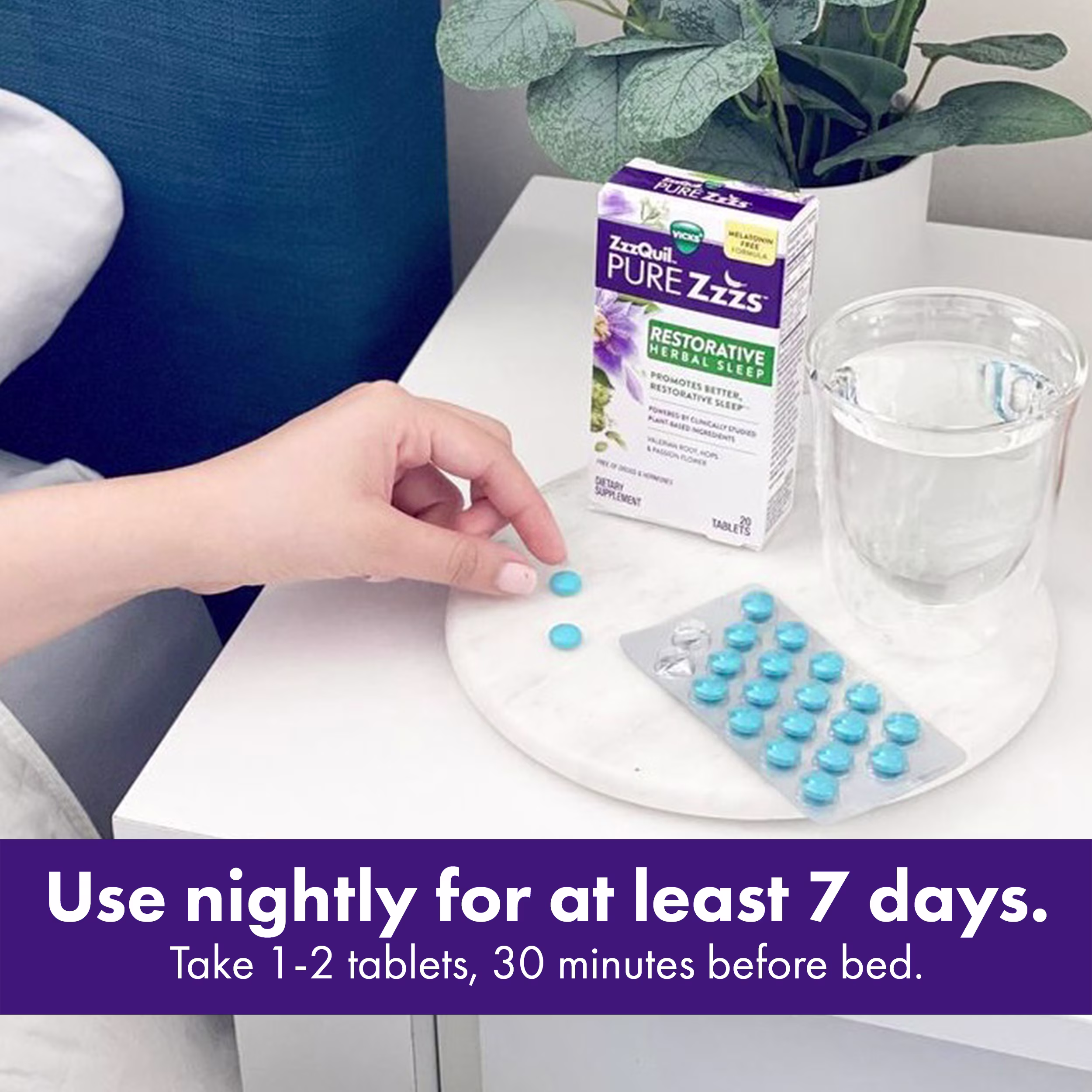 Hand picking a blue sleep aid tablet next to a glass of water and ZzzQuil Pure Zzzs Restorative Herbal Sleep box pack placed on a white tray and "Use nightly for at least 7 days. Take 1-2 tablets, 30 minutes before bed".