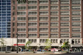 An exterior photograph of the 1001 Woodward Garage tenant spaces.