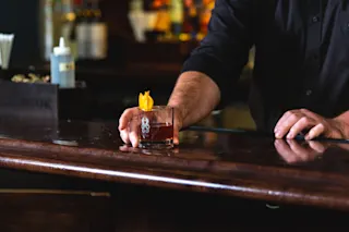 A photo featuring a cocktail made at Buhl Bar inside the Buhl Building.