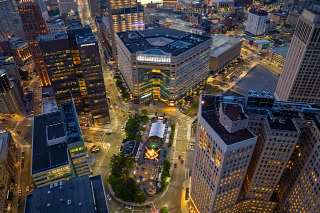 An aerial photograph of One Campus Martius and the surrounding downtown Detroit area, including the Woodward corridor.