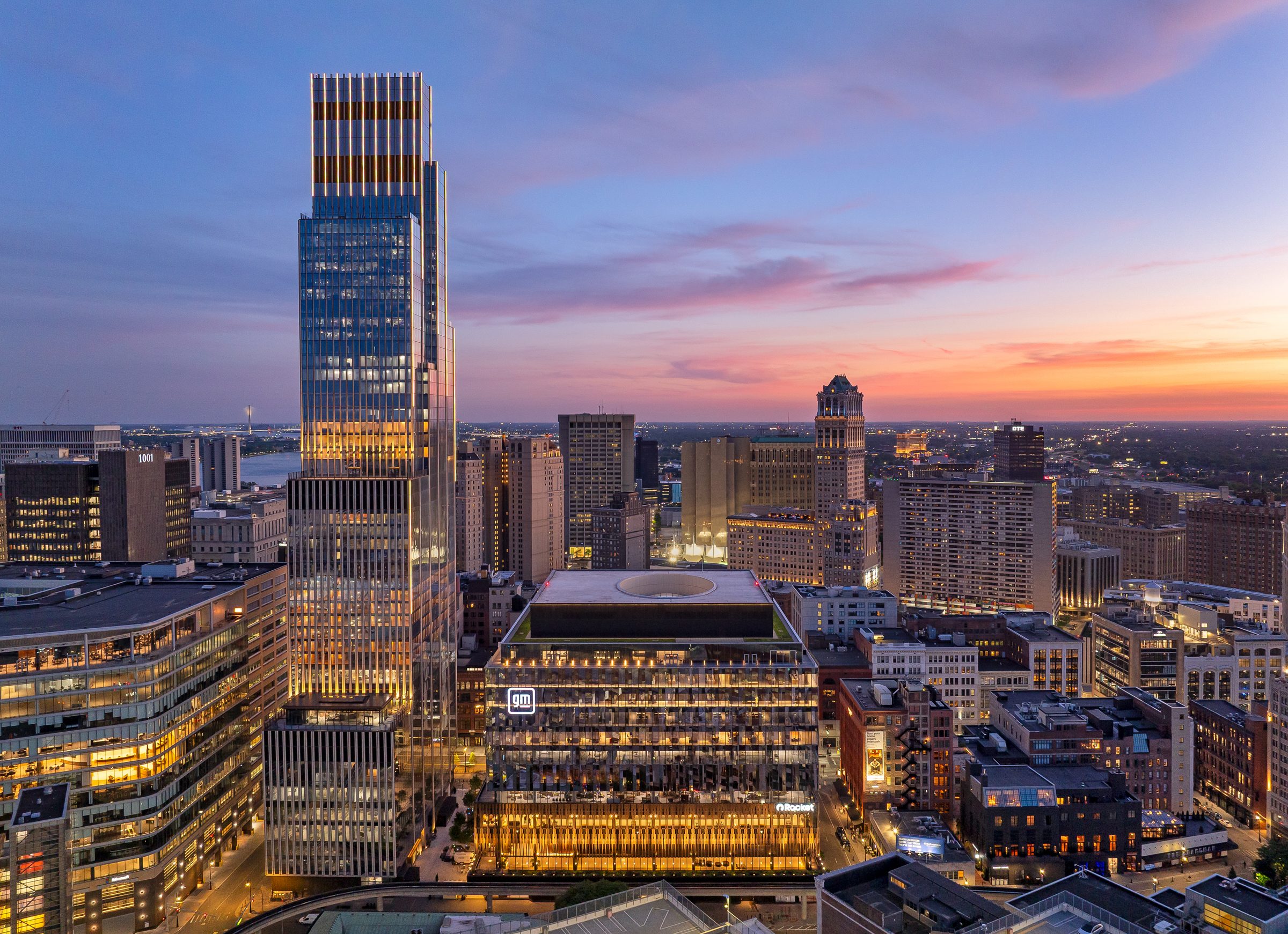 Aerial photo of Hudson’s Detroit, featuring the Block and Edition tower, at nighttime.