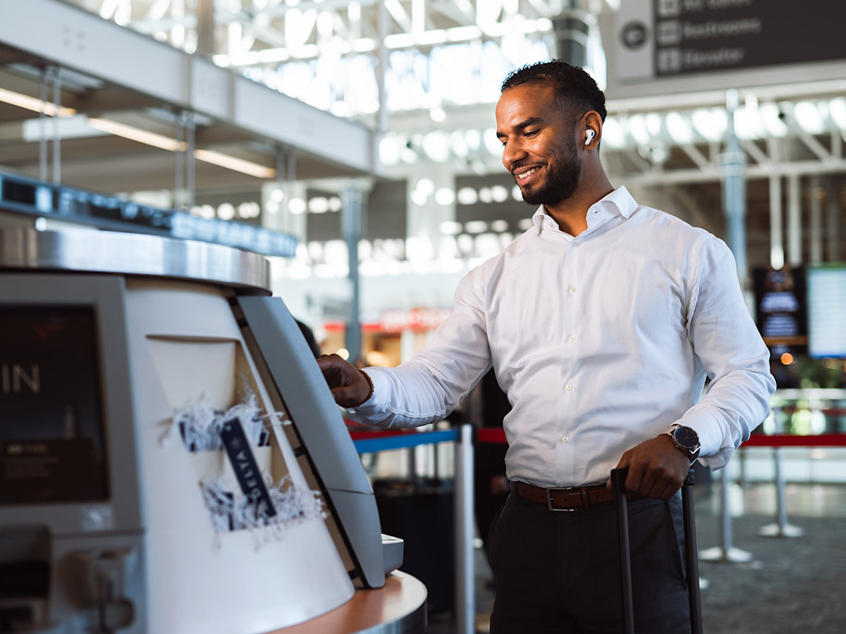 Man using self-service check-in kiosk