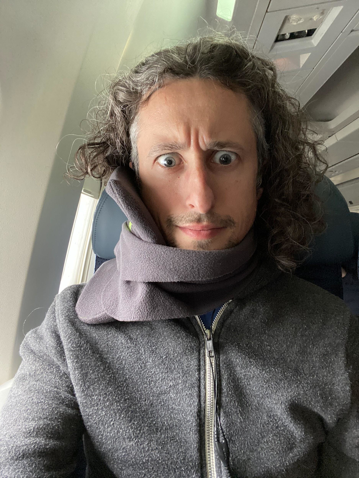 Jay with Travel Pillow on Plane