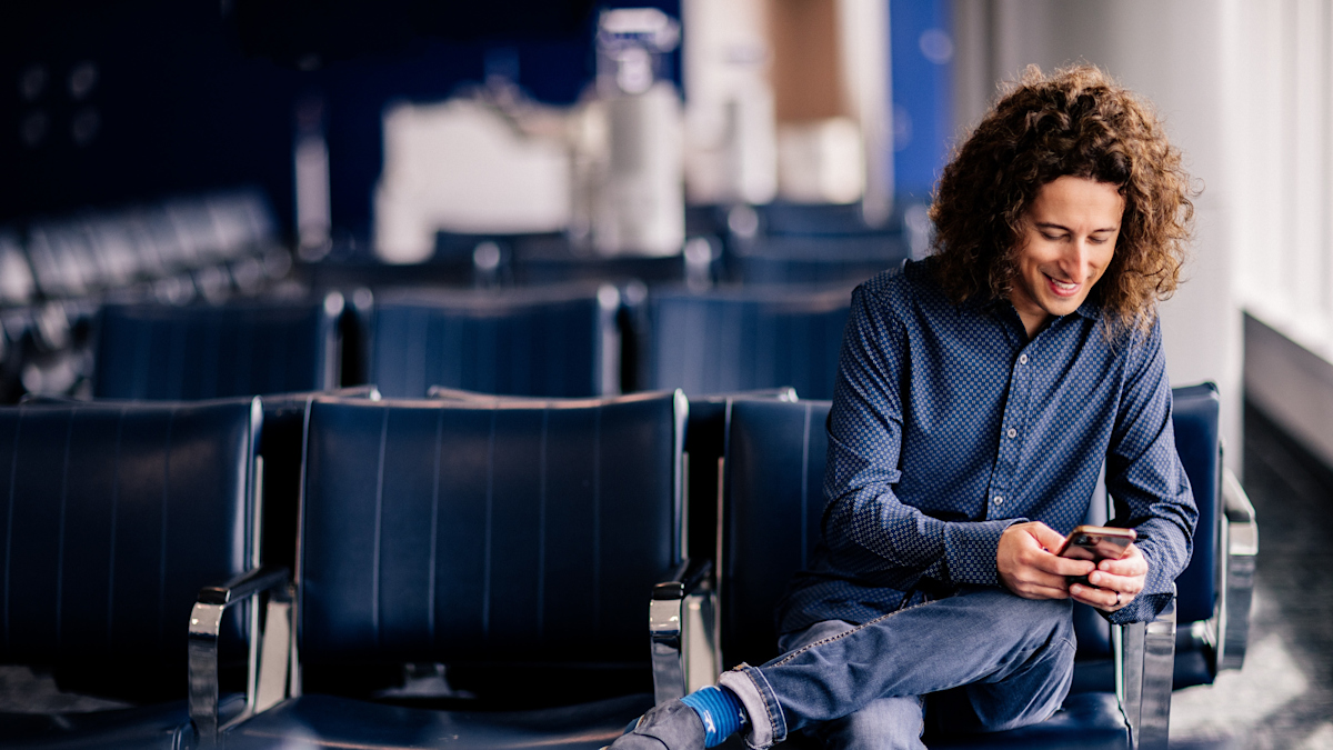 Jay Kruz sitting at a gate