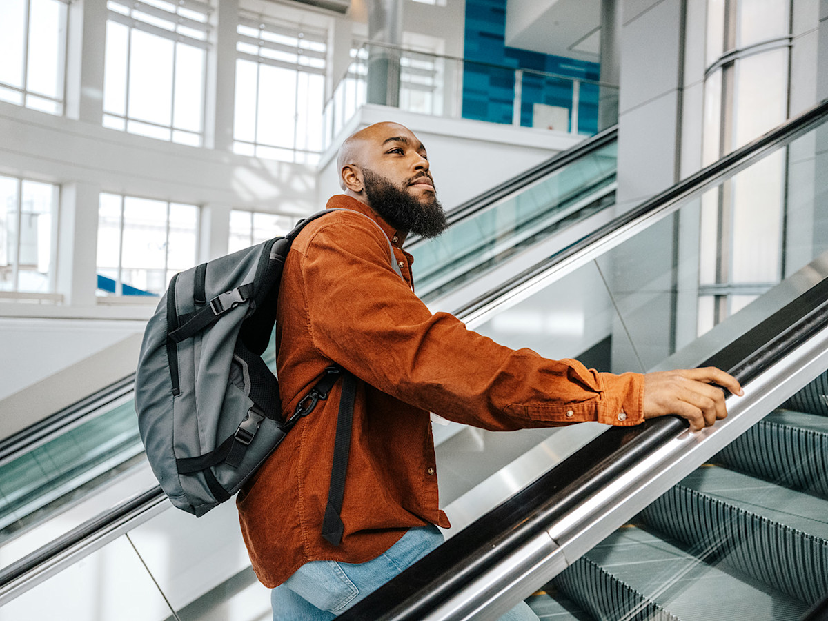 A male passenger uses the escalator.