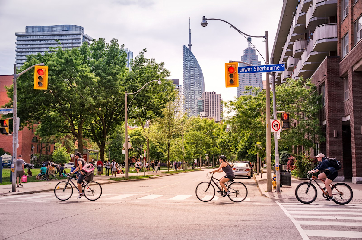 Cyclists going across a crosswalk in Toronto