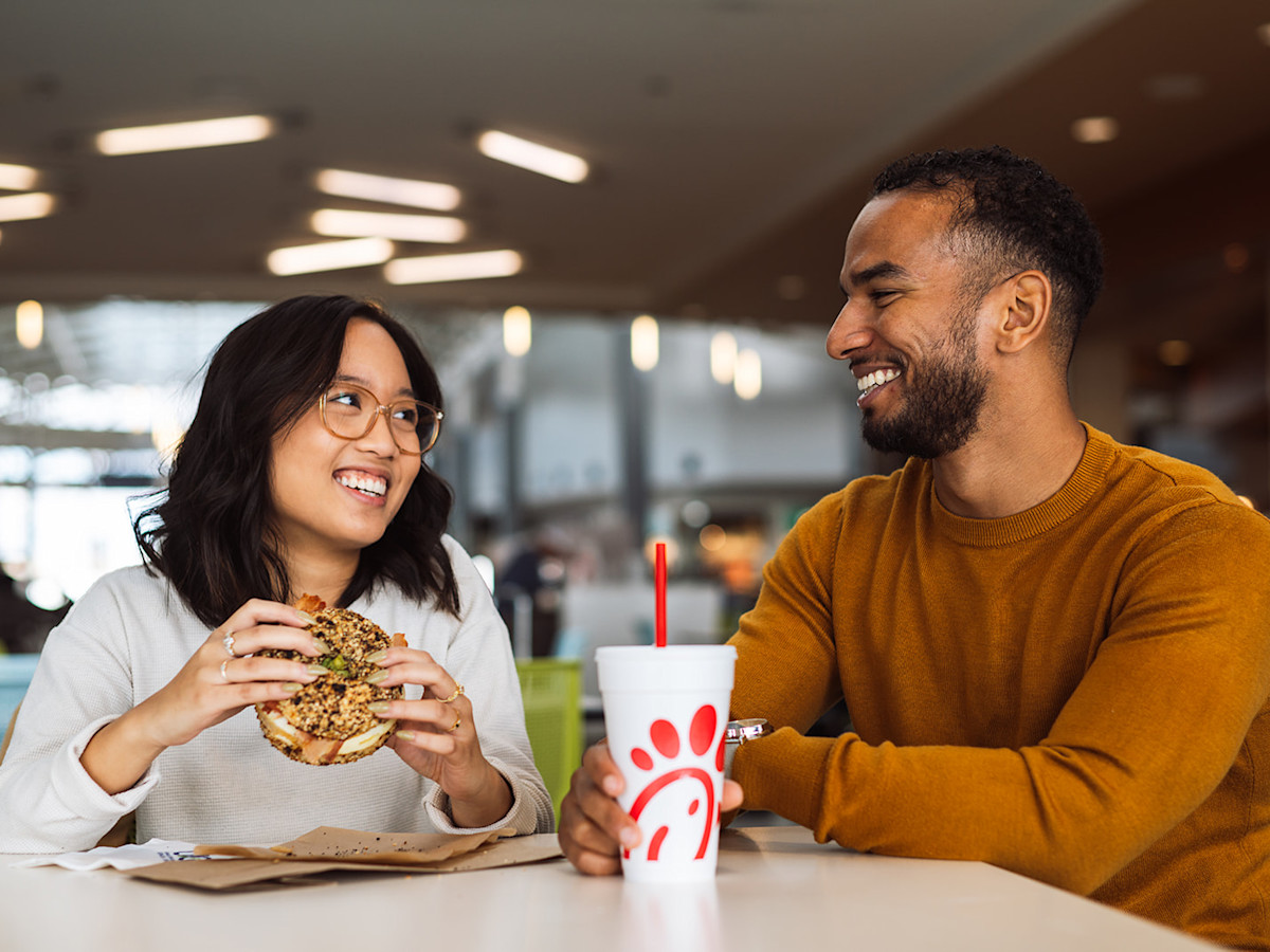 A photo of passengers dining at the Concourse B food court.