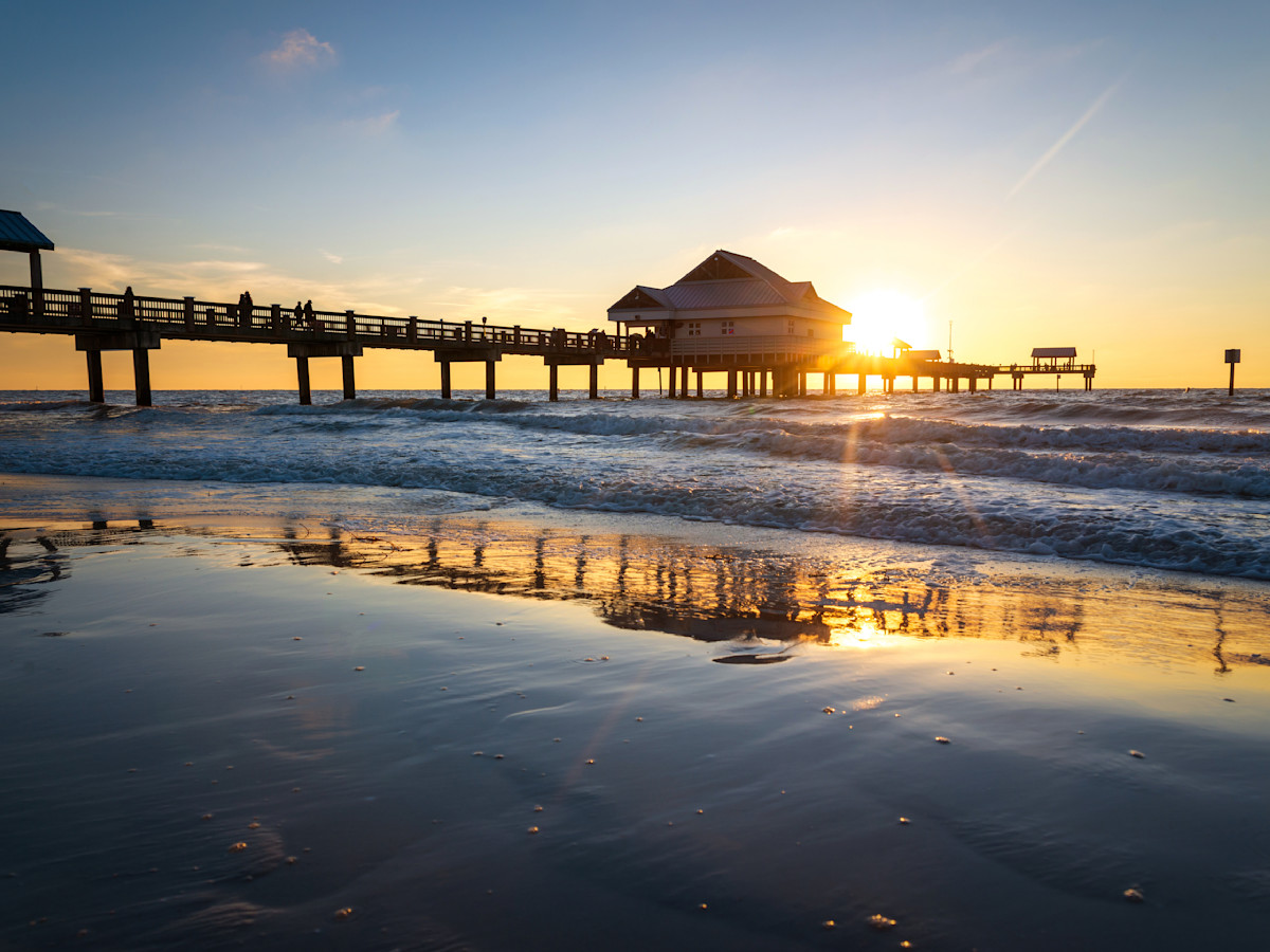 A photo of a pier at Clearwater Beach at sunset.