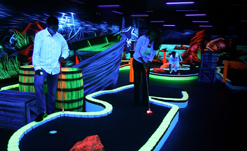 Guests playing glow in the dark golf