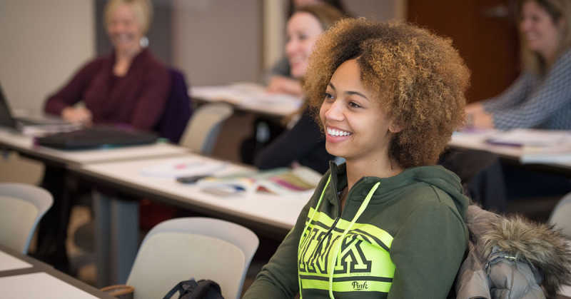 Photograph of student smiling taking the MBA Class