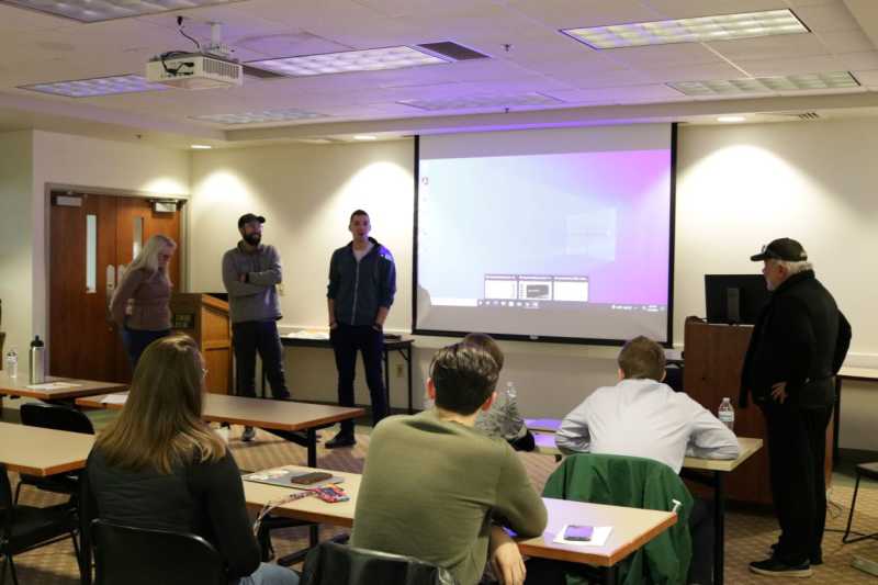 Photograph of Entrepreneurship Students and Faculty Member Peter Apicella as they go over ideaLabs Presentations. 
